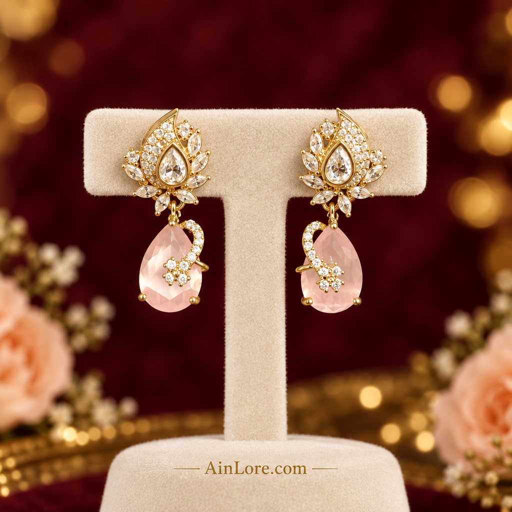 Pale-pink earrings on a luxury stand