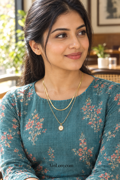 Ananya wearing the layered daisy necklace at a café