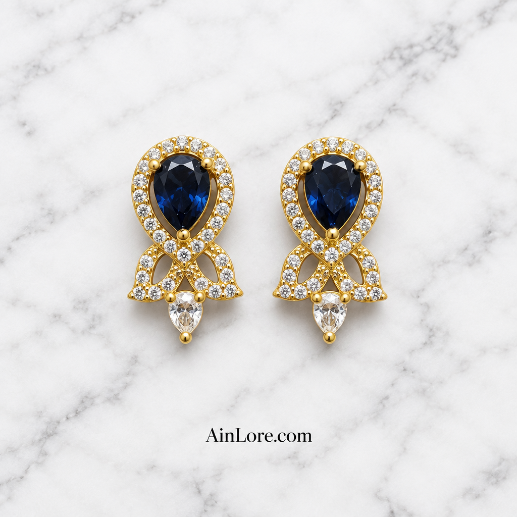 Blue earrings on marble