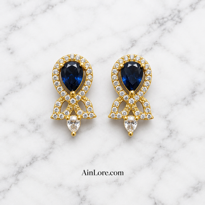 Blue earrings on marble