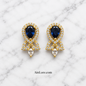 Blue earrings on marble