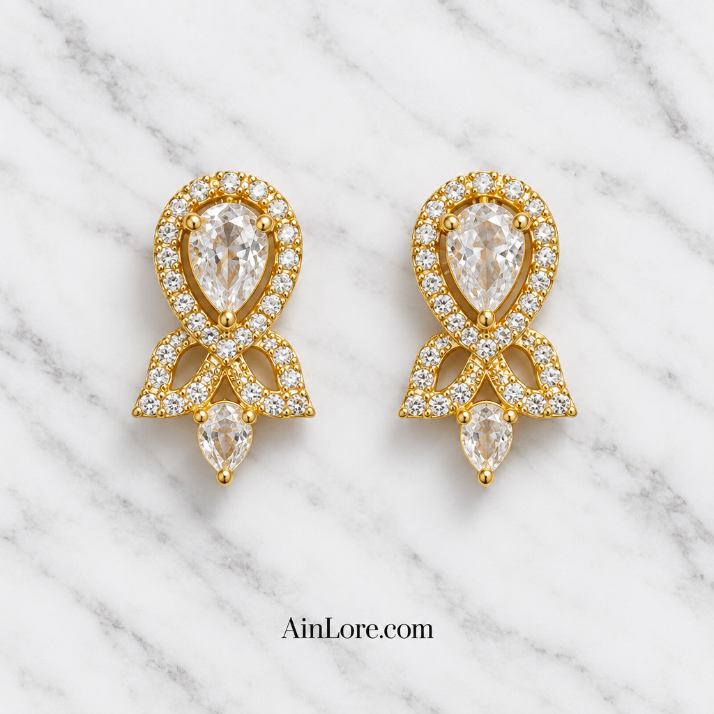 Clear-stone earrings on marble