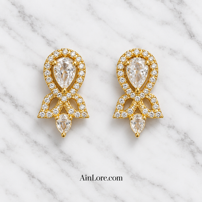 Clear-stone earrings on marble