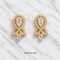 Clear-stone earrings on marble