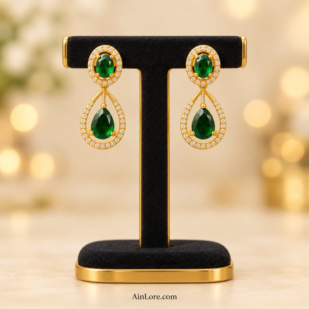 Emerald teardrop earrings on a T-stand