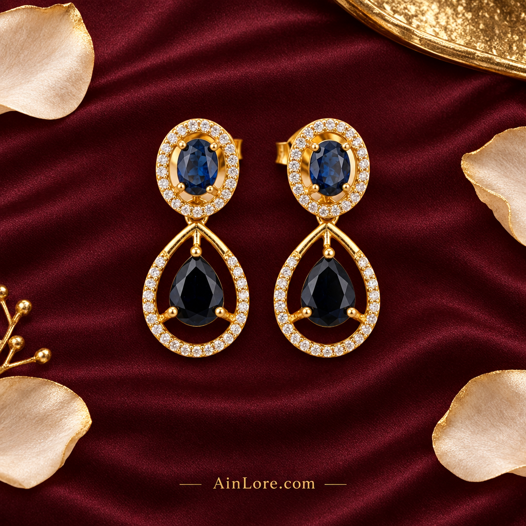 Flatlay of the blue-stone earring pair on burgundy silk