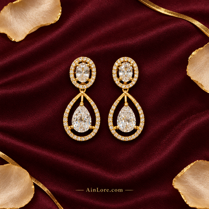 Flatlay of the earring pair on burgundy silk