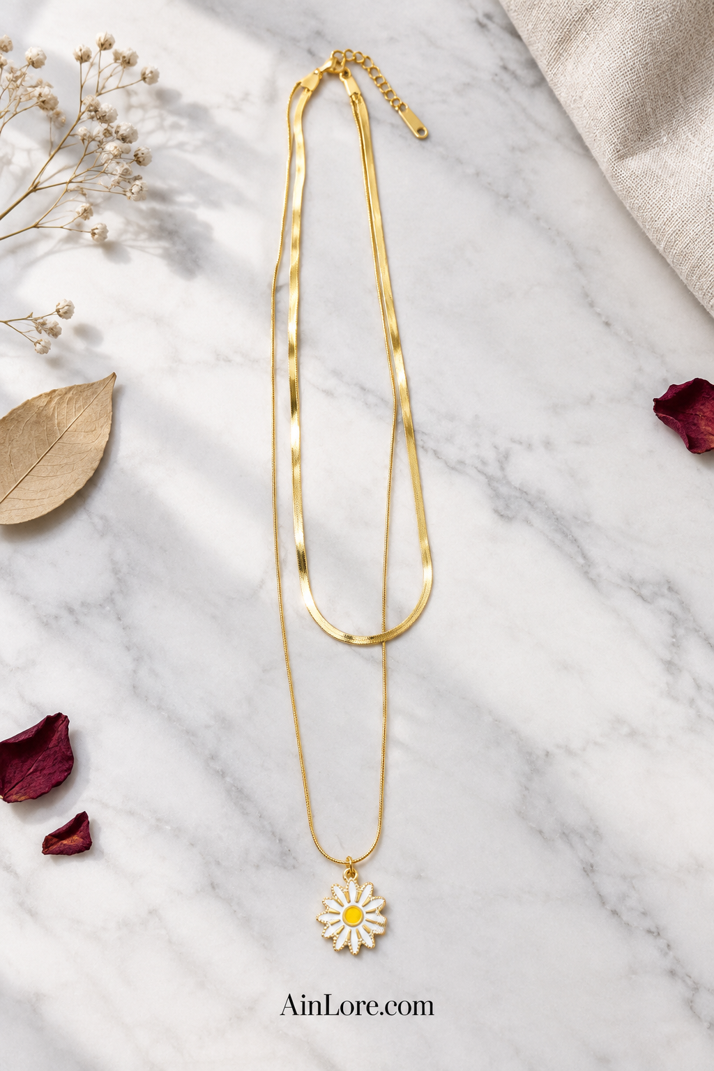 Full daisy necklace flatlay on marble