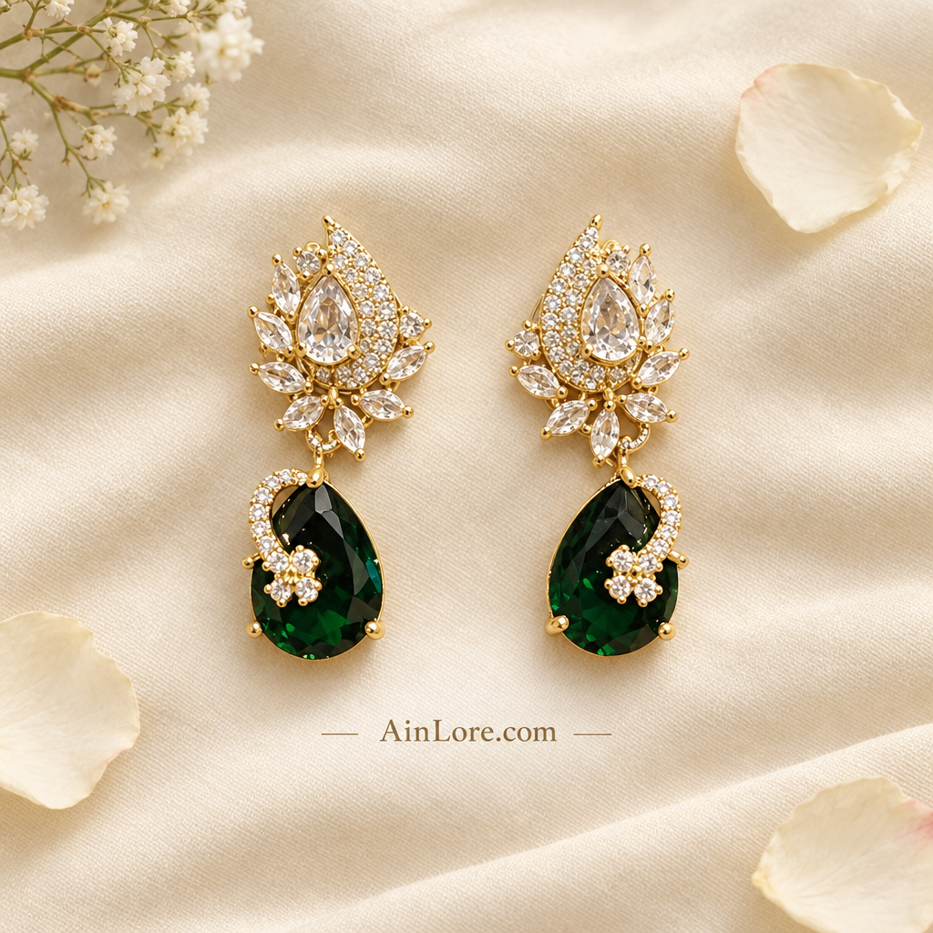 Green-drop earrings on cream fabric