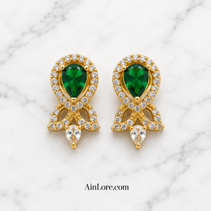 Green earrings on marble