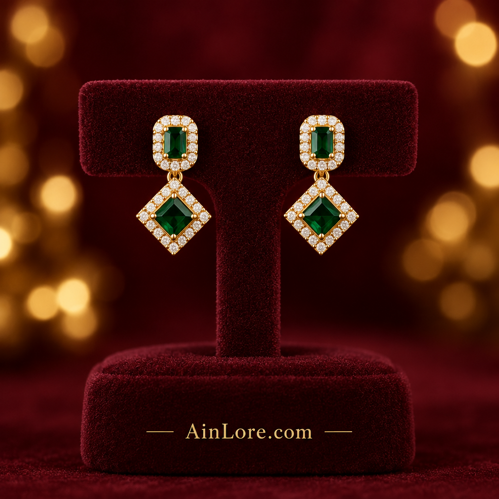 Green geometric earrings on a display stand