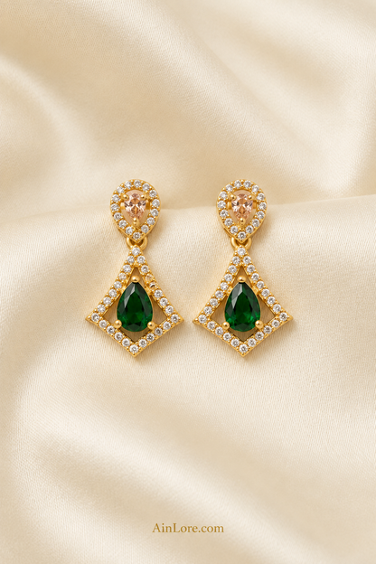 Green kite-drop earrings on cream ribbed fabric