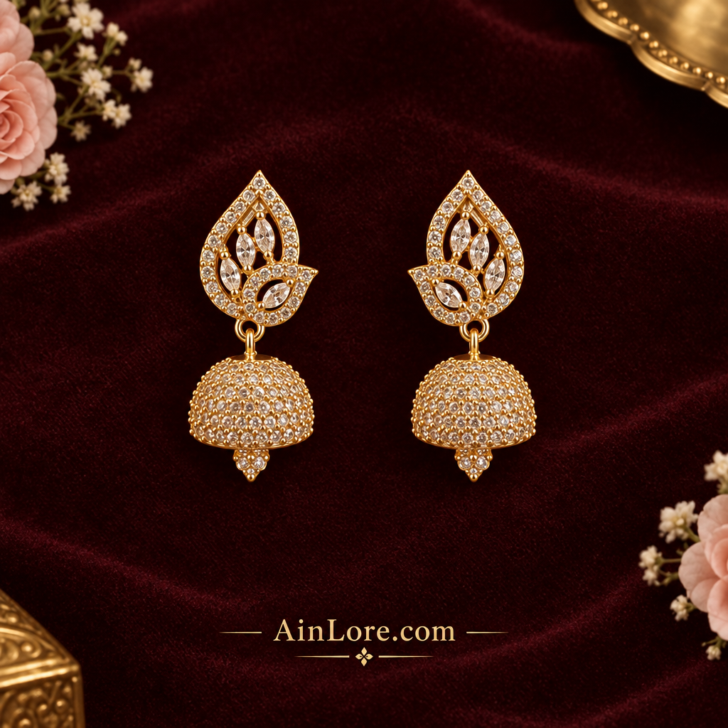 Leaf-top jhumkas on dark burgundy fabric