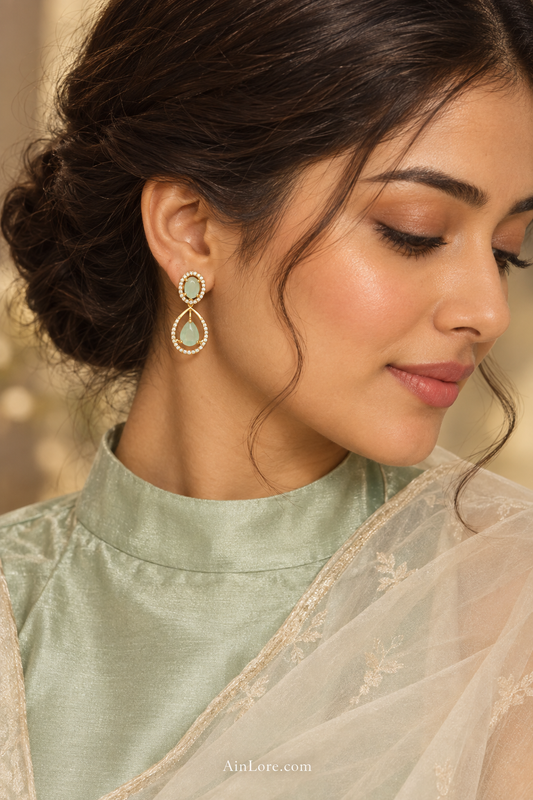 Meena wearing mint green teardrop earrings