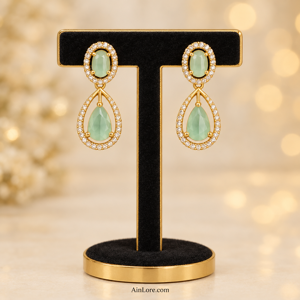 Mint green teardrop earrings on a T-stand
