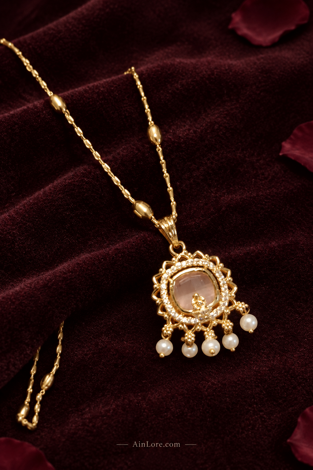 Necklace flatlay on dark velvet with petals