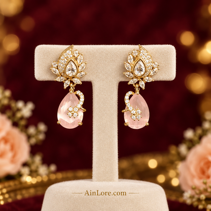 Pale-pink earrings on a luxury stand