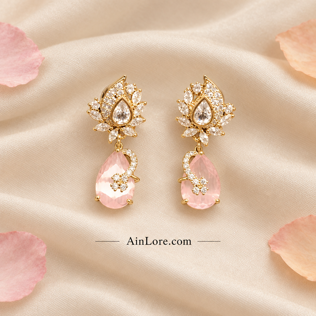Pale-pink earrings on cream fabric with petals