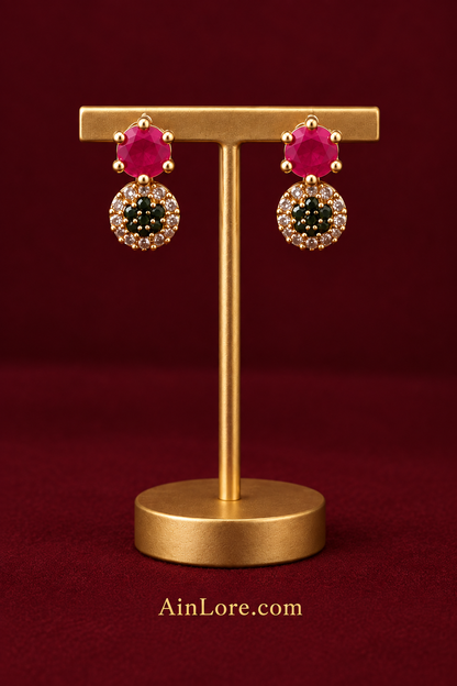 Pink-and-dark-stone earrings on stand