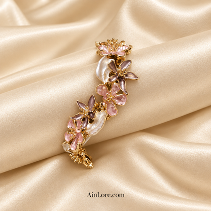 Pink-and-mauve bracelet on a cream satin roll and backdrop