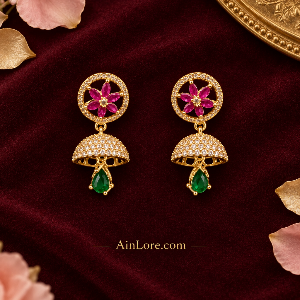 Pink-flower and green-drop jhumkas on burgundy velvet