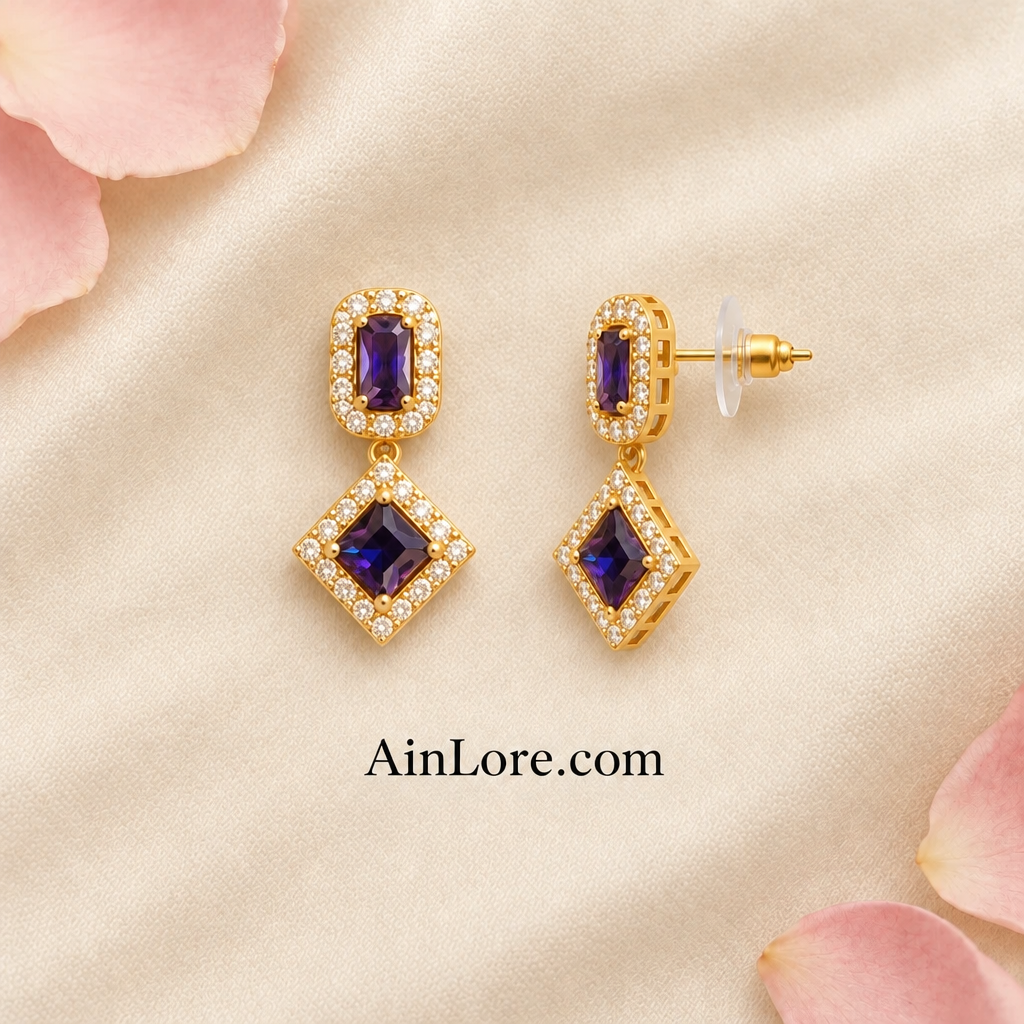 Purple geometric earrings with one tilted to show the clasp