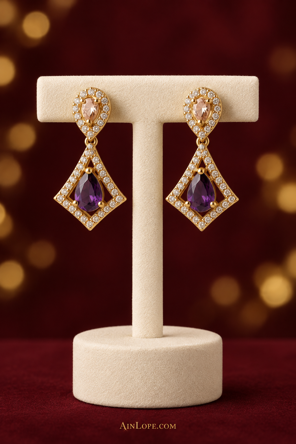 Purple kite-drop earrings on a T-stand
