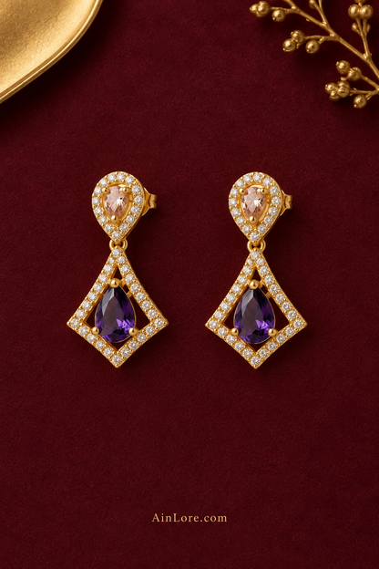 Purple kite-drop earrings on burgundy