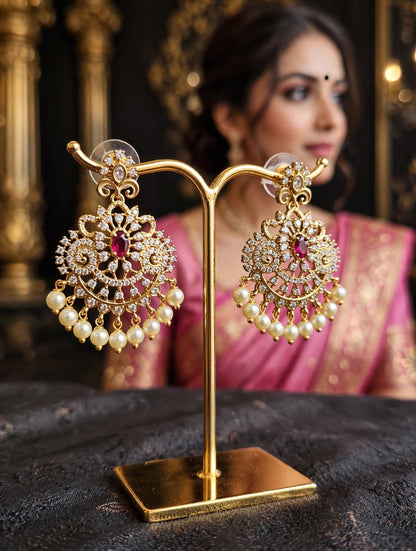 Close-up of matching pearl-drop earrings